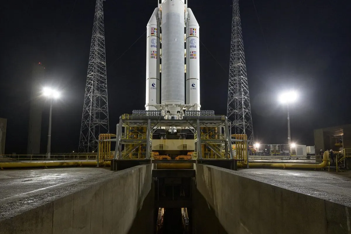 An Ariane 5 rocket standing on its launch pad at night under floodlights