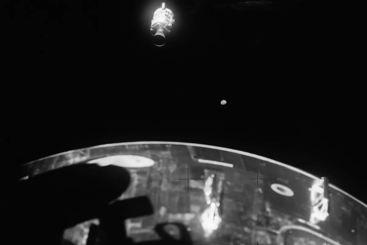 The damaged service module of Apollo 13 seen from the spacecraft with a whole panel missing