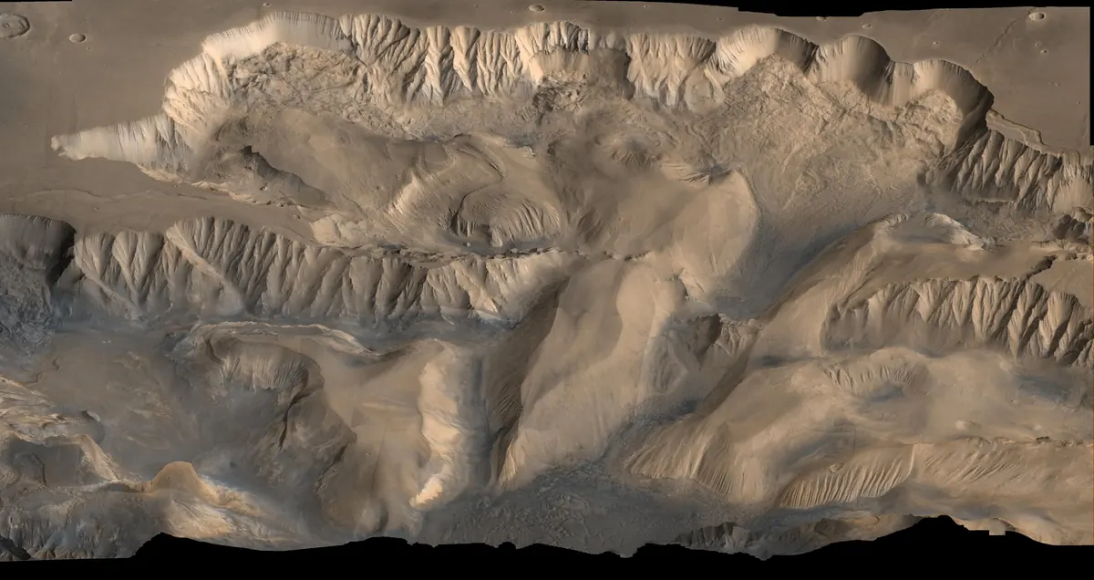A tan canyon system on Mars seen at an angle