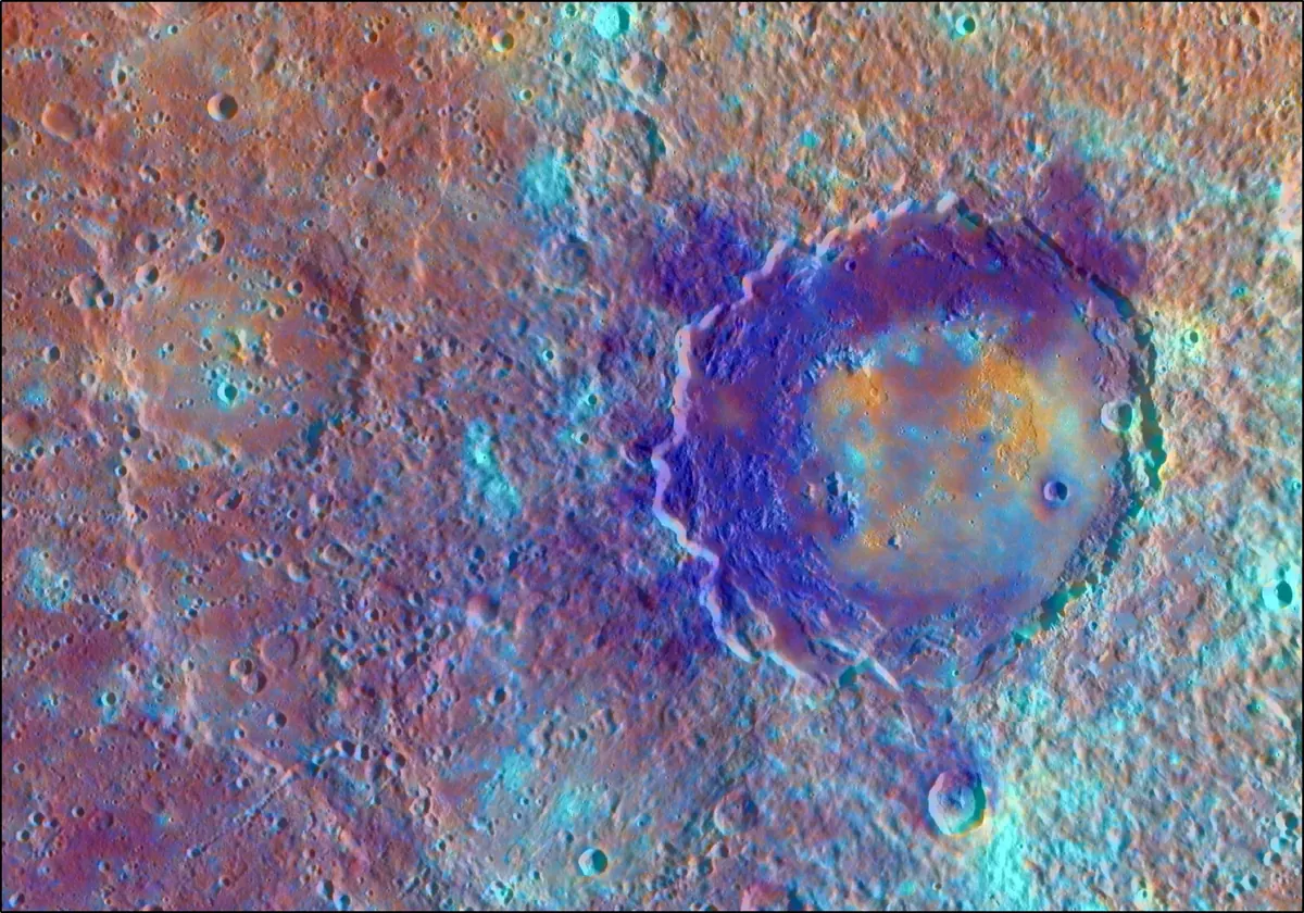 A large crater basin on Mercury in enhanced color, with red and blue patches