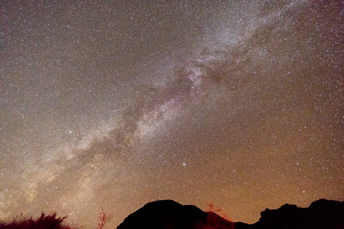 The Milky Way arching across a dark sky above the Big Bend desert