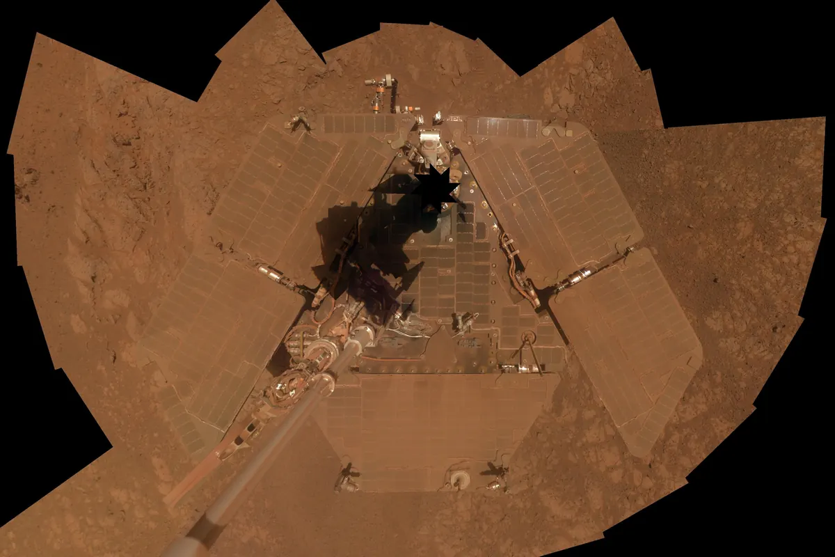 A self-portrait mosaic of the Opportunity rover on rust-colored ground