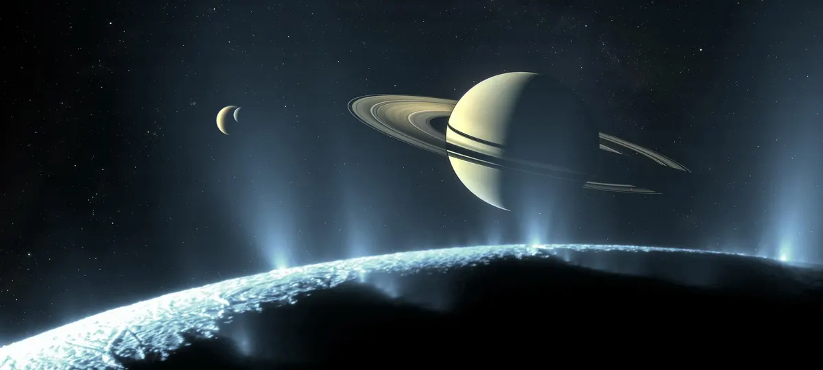 A scene on an icy moon with geysers rising and Saturn and its rings in the sky